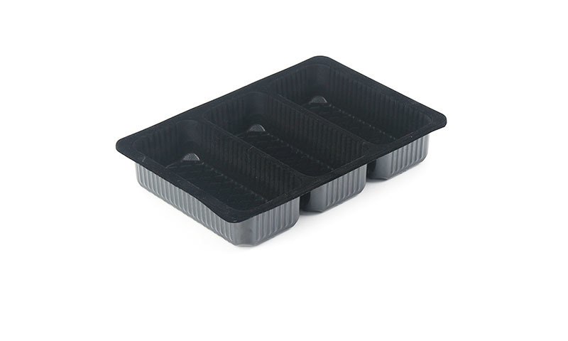 Black frozen food plastic trays for ready meals and frozen seafood on white background